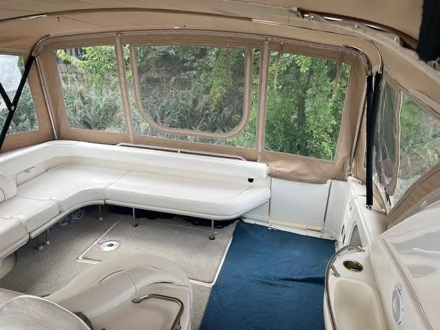 My Girl Yacht Photos Pics Interior of 1995 Sea Ray 450 Sundancer with white seating and large windows.