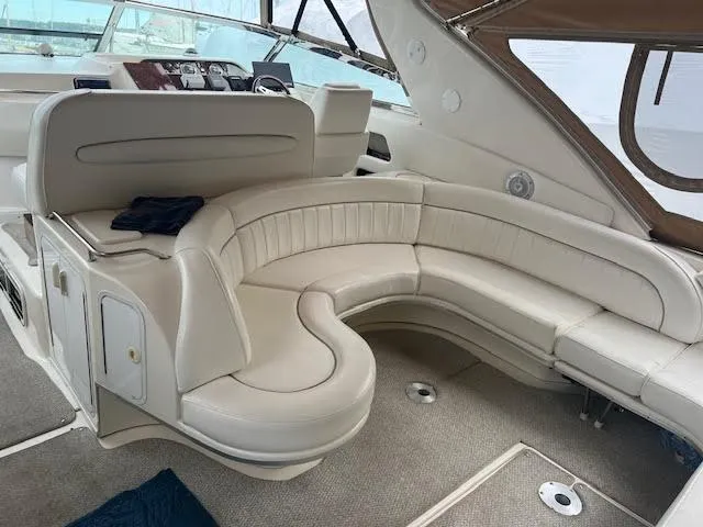 My Girl Yacht Photos Pics 1995 Sea Ray 450 Sundancer interior with curved white seating and helm.