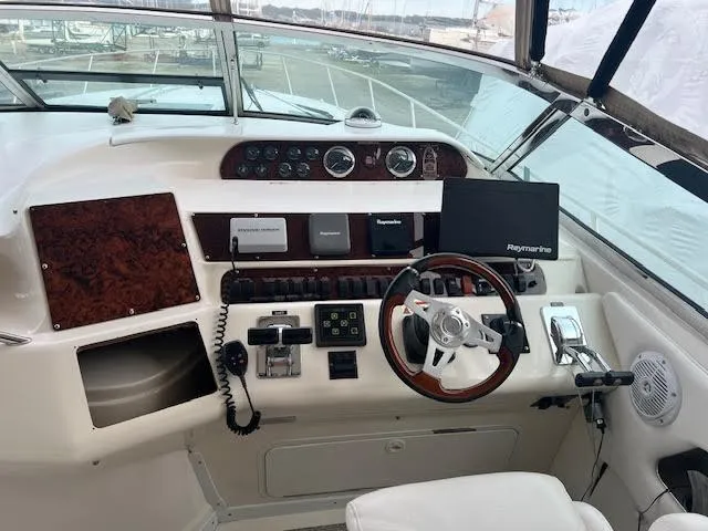 My Girl Yacht Photos Pics 1995 Sea Ray 450 Sundancer helm with steering wheel, navigation controls, and Raymarine display.