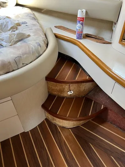My Girl Yacht Photos Pics Interior of 1995 Sea Ray 450 Sundancer with wooden steps and cozy cabin decor.