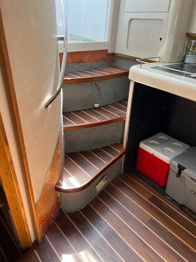 My Girl Yacht Photos Pics Interior stairs of 1995 Sea Ray 450 Sundancer with wood finish and compact kitchen area.