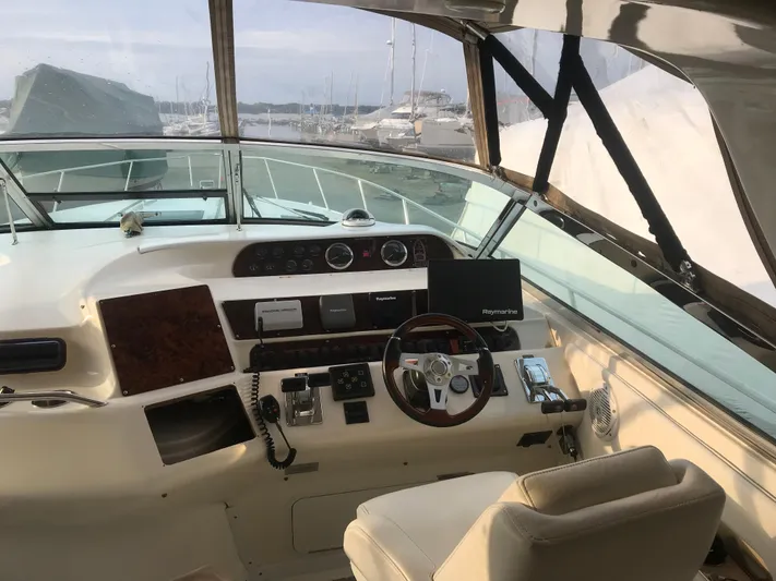My Girl Yacht Photos Pics Interior helm of 1995 Sea Ray 450 Sundancer yacht with steering wheel and navigation equipment.
