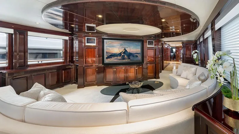 Ionian Princess Yacht Photos Pics Luxurious 2005 Christensen yacht interior with elegant wood paneling and curved white sofa.