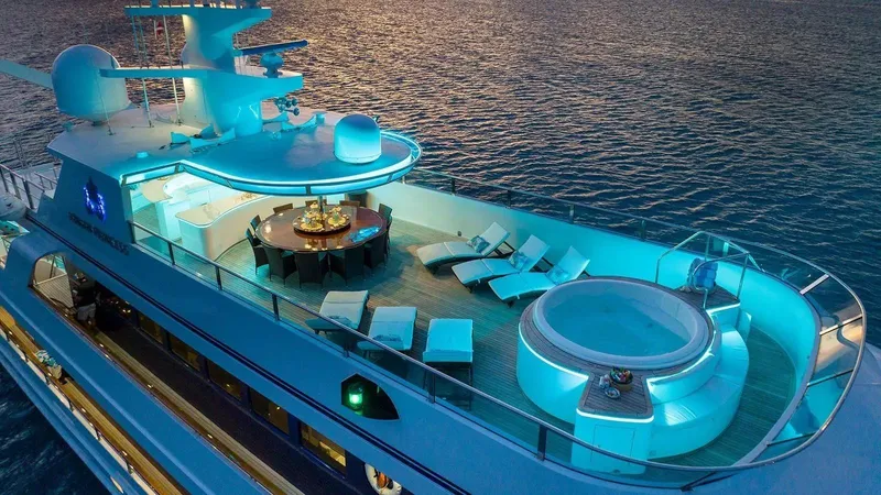 Ionian Princess Yacht Photos Pics Luxurious 2005 Christensen yacht with illuminated deck, hot tub, and lounge area at sunset.