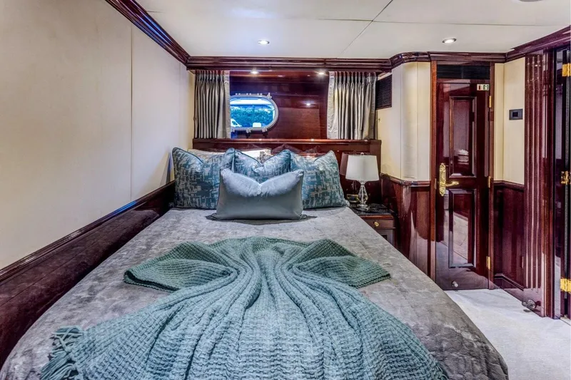 Ionian Princess Yacht Photos Pics Luxurious bedroom interior on a 2005 Christensen yacht with elegant bedding and wood accents.