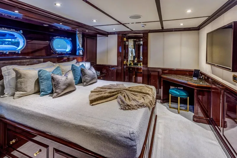 Ionian Princess Yacht Photos Pics Luxurious 2005 Christensen yacht bedroom with elegant wood paneling and plush bedding.