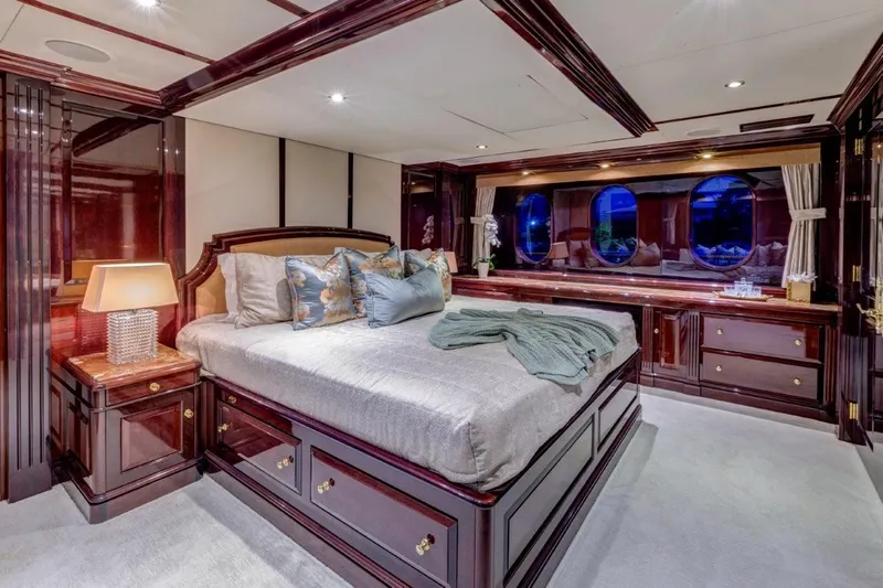 Ionian Princess Yacht Photos Pics Luxurious bedroom interior on a 2005 Christensen yacht with elegant wood finishes.