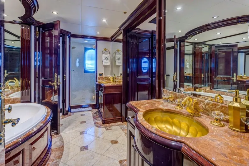 Ionian Princess Yacht Photos Pics Luxurious yacht bathroom with marble countertops, gold fixtures, and elegant wood finishes, Christensen 2005 model.