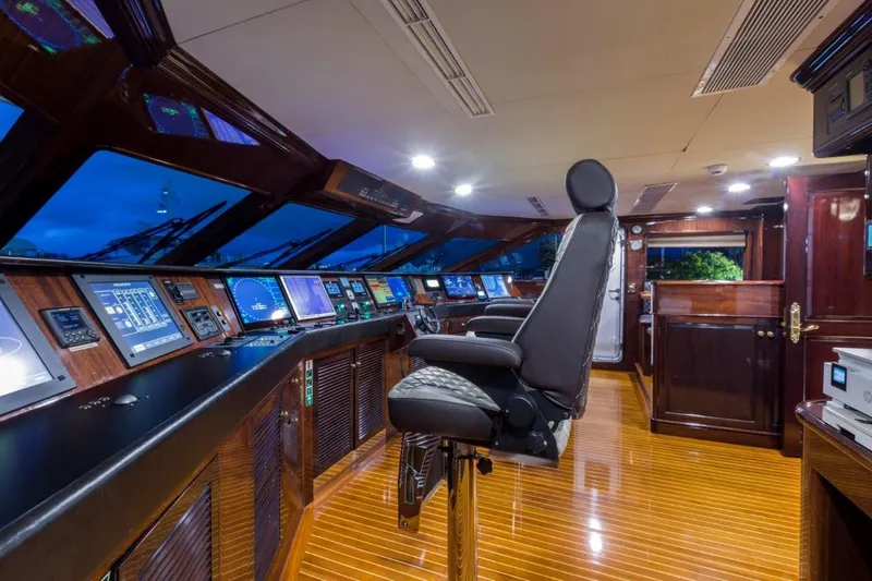 Ionian Princess Yacht Photos Pics Luxurious yacht cockpit with advanced navigation systems, Christensen 2005 model, featuring sleek wooden flooring.