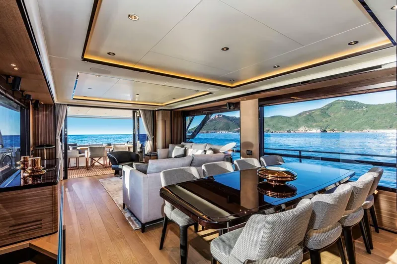  Yacht Photos Pics Luxurious interior of 2019 Absolute Navetta 73 yacht with ocean view and elegant dining area.