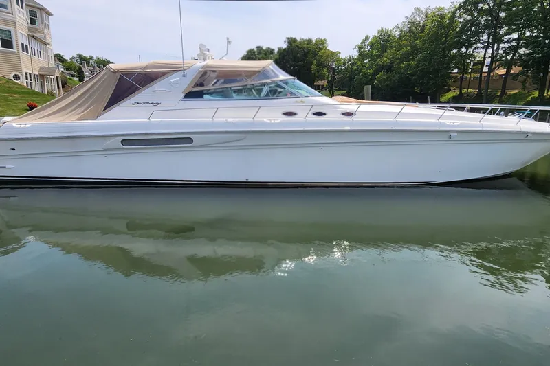  Yacht Photos Pics 1998 Sea Ray 630 Super Sun Sport yacht docked on calm water.