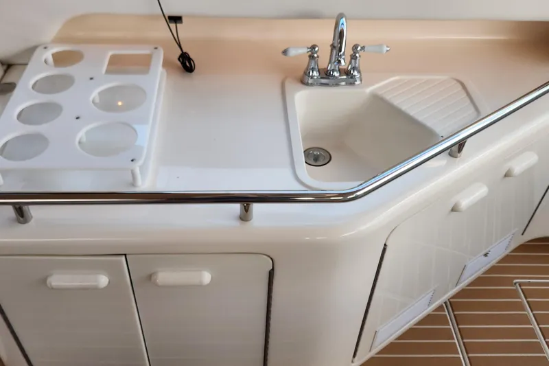  Yacht Photos Pics 1998 Sea Ray 630 Super Sun Sport yacht kitchenette with sink and storage cabinets.