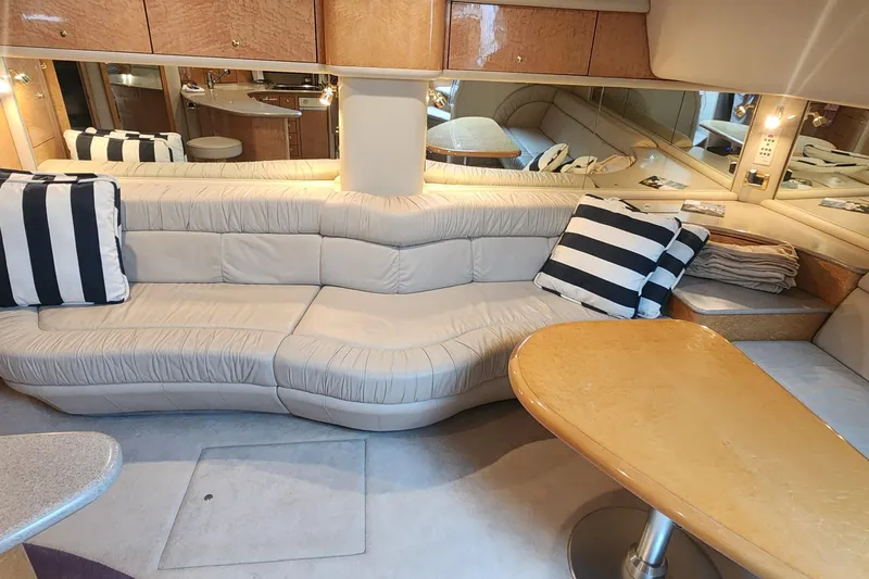  Yacht Photos Pics Luxurious interior of 1998 Sea Ray 630 Super Sun Sport yacht with plush seating and striped cushions.