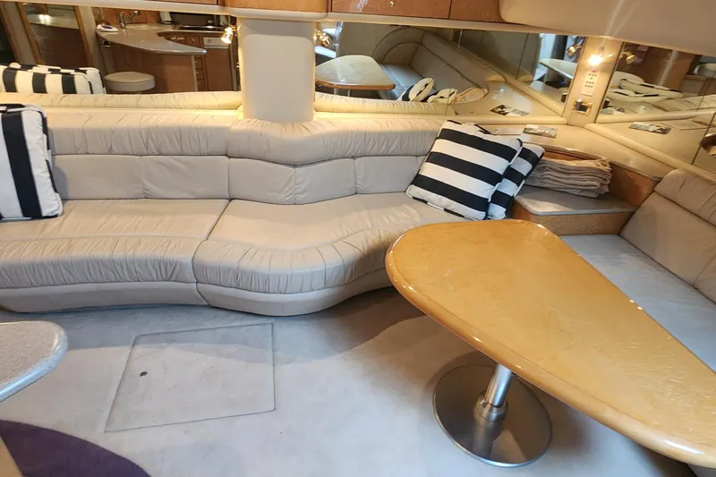  Yacht Photos Pics Luxurious interior of 1998 Sea Ray 630 Super Sun Sport yacht with plush seating and striped cushions.