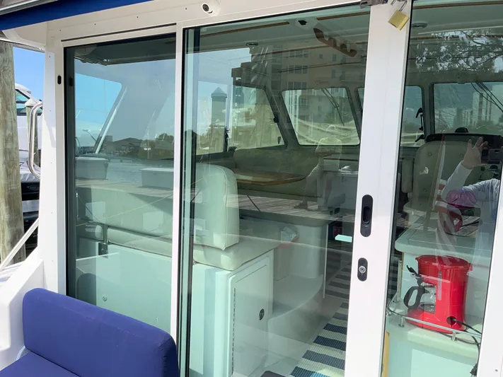  Yacht Photos Pics 2016 Back Cove 34 Express boat interior with glass sliding doors and seating area.