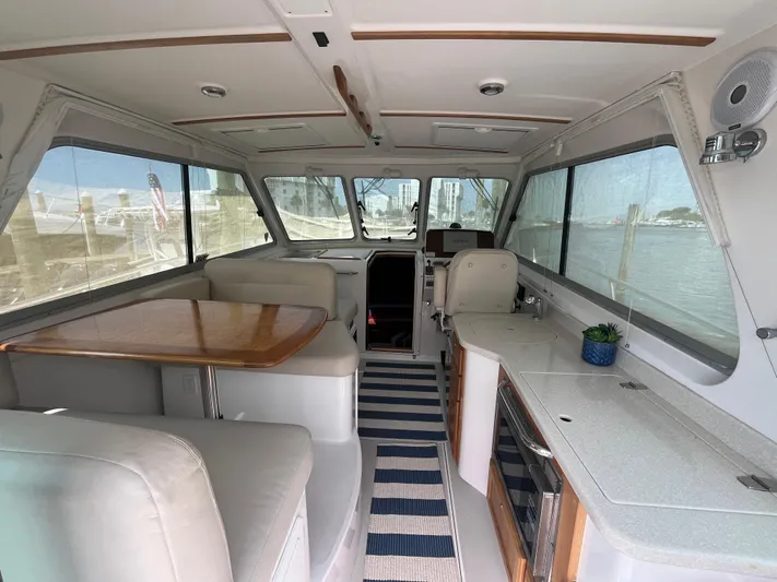  Yacht Photos Pics Interior of 2016 Back Cove 34 Express yacht with seating, table, and striped rug.
