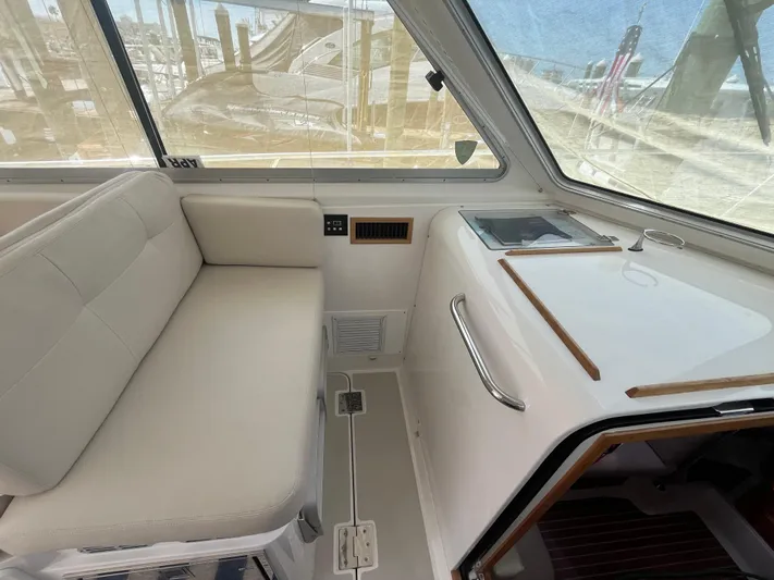  Yacht Photos Pics 2016 Back Cove 34 Express interior with white seating and window view.