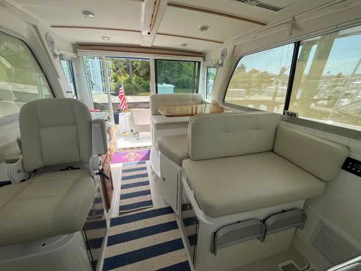  Yacht Photos Pics Interior of 2016 Back Cove 34 Express yacht with beige seating and striped carpet.