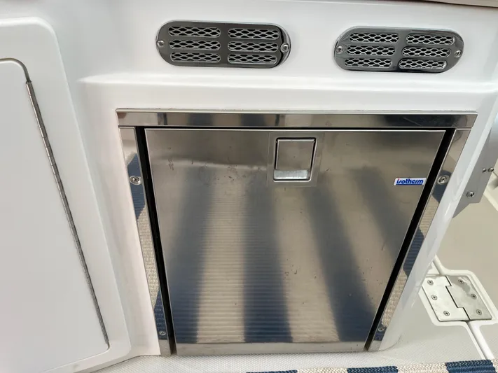 Yacht Photos Pics Stainless steel fridge on 2016 Back Cove 34 Express boat, featuring ventilation grilles.