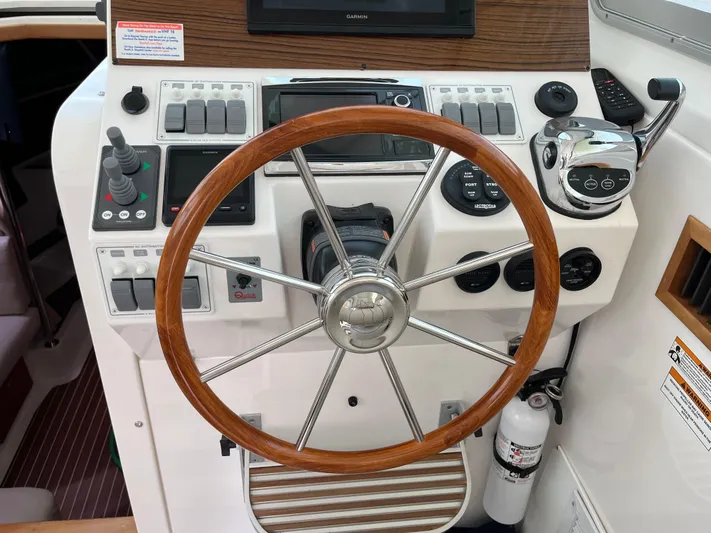  Yacht Photos Pics Helm of 2016 Back Cove 34 Express with wooden steering wheel and control panel.
