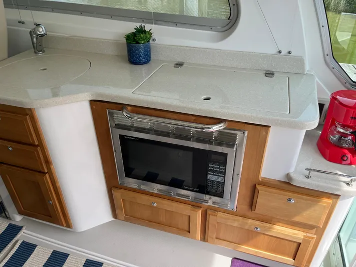  Yacht Photos Pics 2016 Back Cove 34 Express galley with microwave, sink, and red coffee maker.