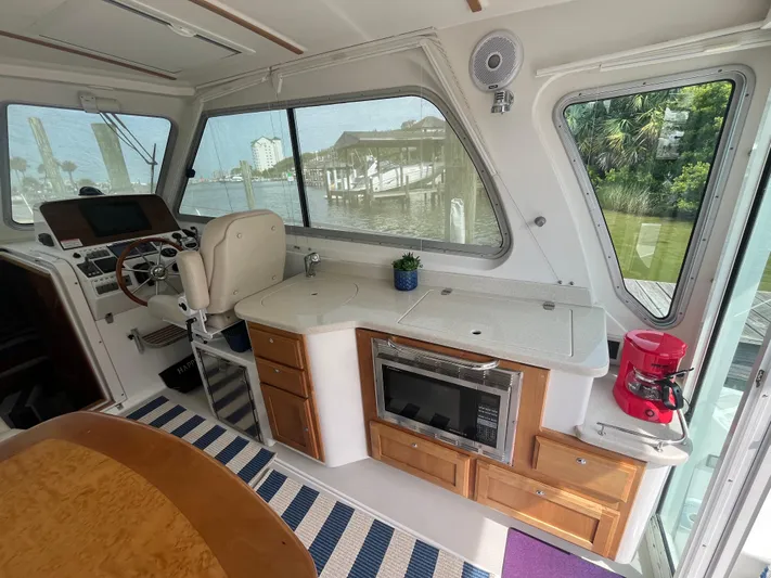  Yacht Photos Pics Interior of 2016 Back Cove 34 Express boat with helm, kitchenette, and seating area.