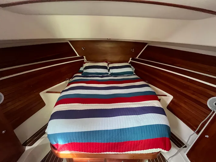  Yacht Photos Pics Cozy cabin interior of 2016 Back Cove 34 Express with striped bedding.