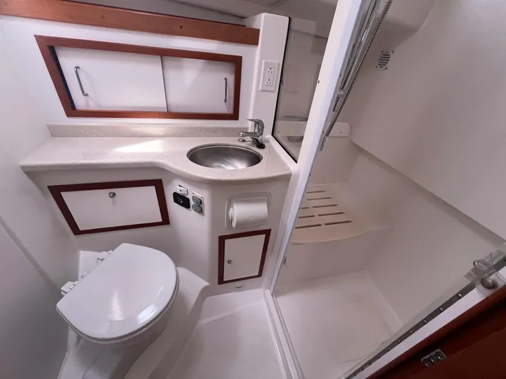  Yacht Photos Pics 2016 Back Cove 34 Express bathroom with sink, toilet, and shower.