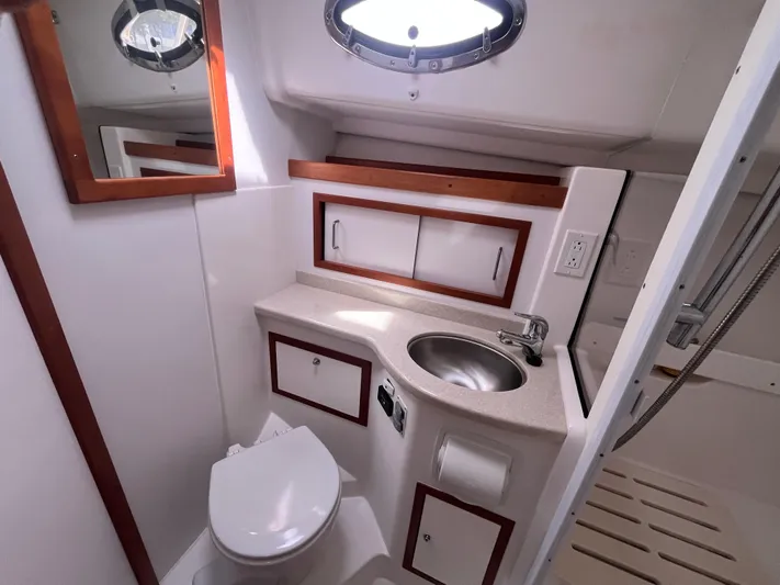  Yacht Photos Pics 2016 Back Cove 34 Express bathroom with sink, toilet, and storage cabinets.