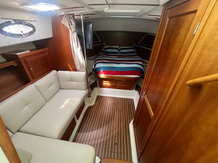  Yacht Photos Pics 2016 Back Cove 34 Express cabin interior with bed, sofa, and wooden finishes.