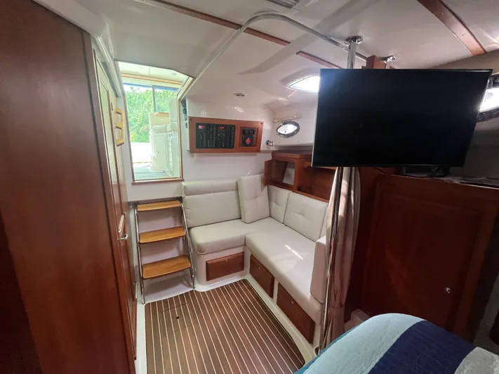  Yacht Photos Pics Interior of 2016 Back Cove 34 Express yacht with seating, stairs, and mounted TV.