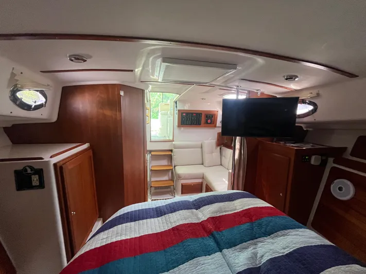  Yacht Photos Pics 2016 Back Cove 34 Express cabin interior with bed, seating, and TV.