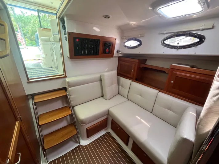  Yacht Photos Pics 2016 Back Cove 34 Express cabin interior with white seating and wooden accents.