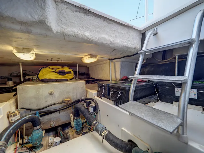 Tight Seal Yacht Photos Pics Engine room of a 2005 Luhrs 41 Convertible boat with equipment and ladder.