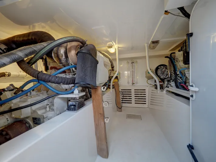 Tight Seal Yacht Photos Pics Engine room of a 2005 Luhrs 41 Convertible boat with visible machinery and piping.