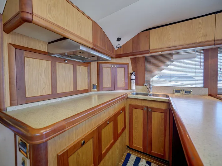 Tight Seal Yacht Photos Pics 2005 Luhrs 41 Convertible yacht kitchen with wooden cabinets and countertops.