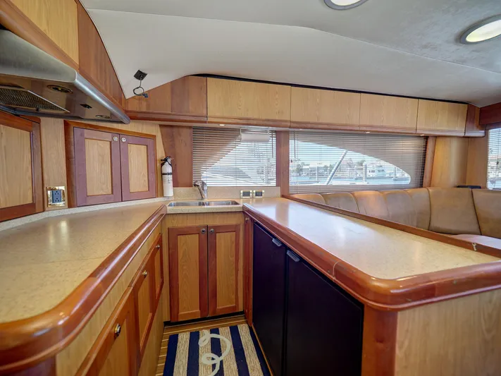 Tight Seal Yacht Photos Pics 2005 Luhrs 41 Convertible yacht kitchen with wood cabinetry and ample counter space.