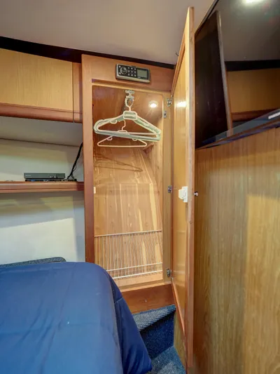 Tight Seal Yacht Photos Pics Open closet in 2005 Luhrs 41 Convertible boat cabin with hangers and shelves.