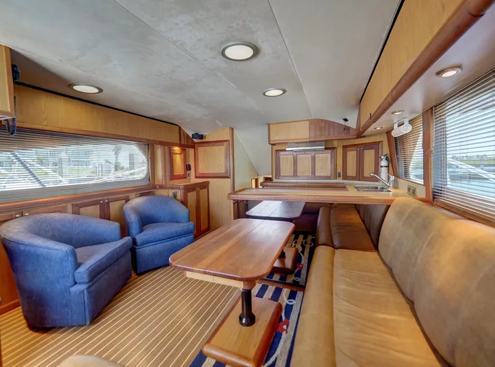 Tight Seal Yacht Photos Pics Interior of 2005 Luhrs 41 Convertible yacht with cozy seating and wooden finishes.