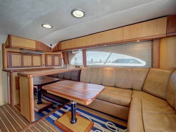 Tight Seal Yacht Photos Pics Interior of 2005 Luhrs 41 Convertible yacht with wooden dining area and leather seating.