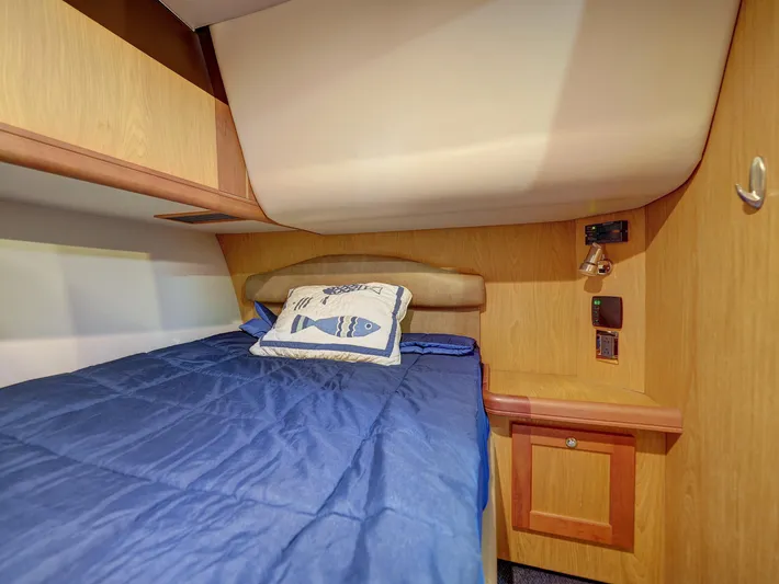 Tight Seal Yacht Photos Pics 2005 Luhrs 41 Convertible cabin with blue bedding and fish-themed pillow.