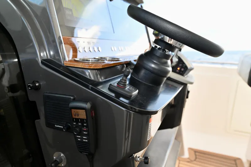 S.y. Royale Yacht Photos Pics 2023 Tiara Sport 38 LS helm with steering wheel and control panel.