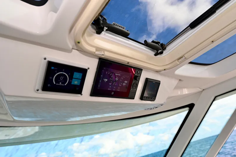 S.y. Royale Yacht Photos Pics 2023 Tiara Sport 38 LS dashboard with digital displays and ocean view.
