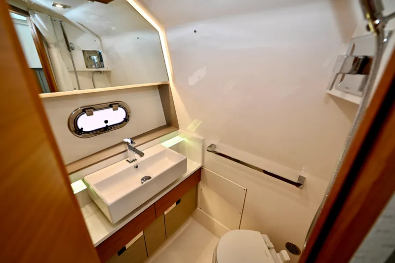 S.y. Royale Yacht Photos Pics 2023 Tiara Sport 38 LS yacht bathroom with modern sink and porthole window.