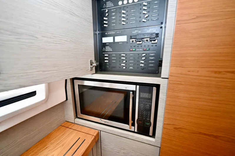 S.y. Royale Yacht Photos Pics Electrical panel and microwave in 2023 Tiara Sport 38 LS yacht interior.