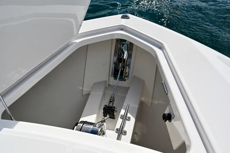 S.y. Royale Yacht Photos Pics Anchor compartment of 2023 Tiara Sport 38 LS boat, open hatch, ocean background.