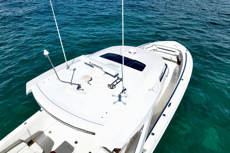 S.y. Royale Yacht Photos Pics 2023 Tiara Sport 38 LS boat on clear blue water, aerial view.