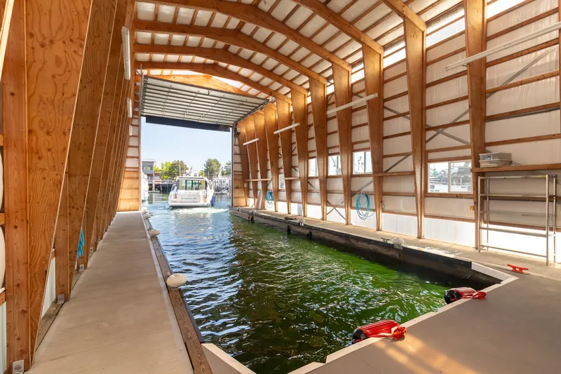 Noor Yacht Photos Pics 2023 Tiara Yachts C44 Coupe in a covered marina slip, showcasing modern design.