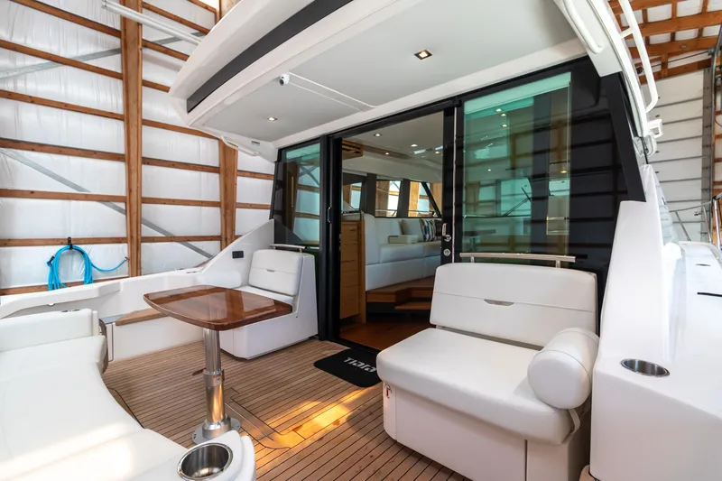 Noor Yacht Photos Pics 2023 Tiara Yachts C44 Coupe interior with elegant seating and wooden accents.