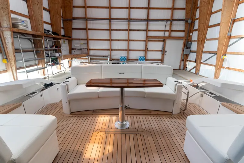Noor Yacht Photos Pics 2023 Tiara Yachts C44 Coupe interior with elegant seating and wooden table.